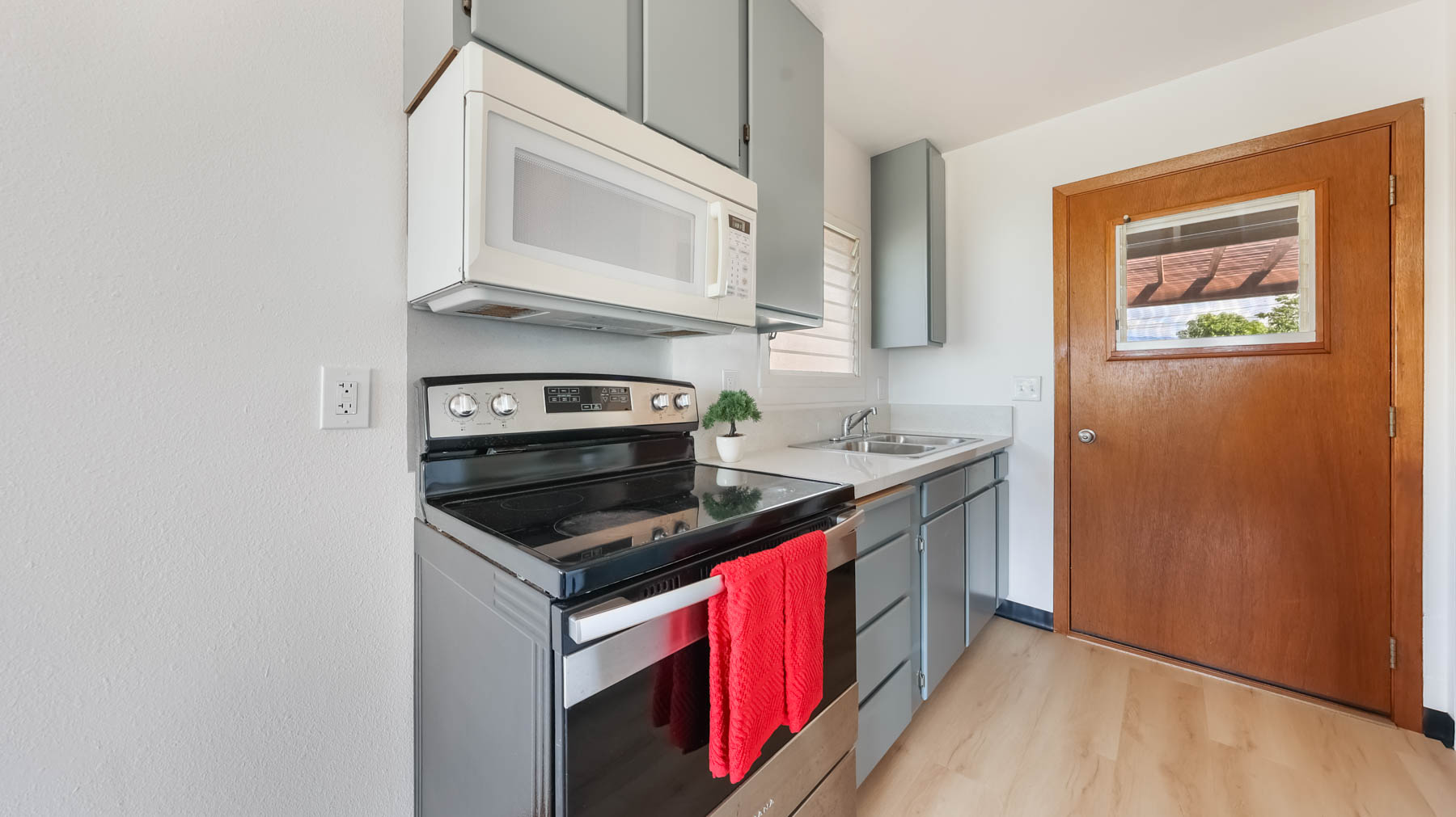 4604 Maile Road Waimea, HI 96796 - Photo 5 of 25 a kitchen with stainless steel appliances granite countertop a stove and a microwave