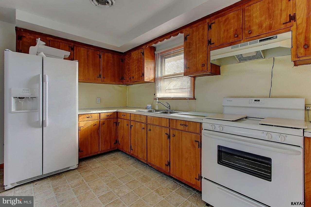 732 Terrace Road York, PA 17404 - Photo 6 of 13 a kitchen with stainless steel appliances granite countertop a refrigerator and a sink