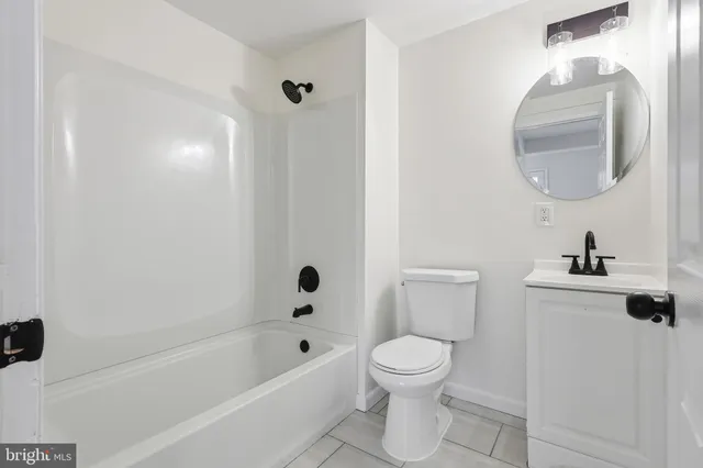 a white toilet sitting next to a bath tub