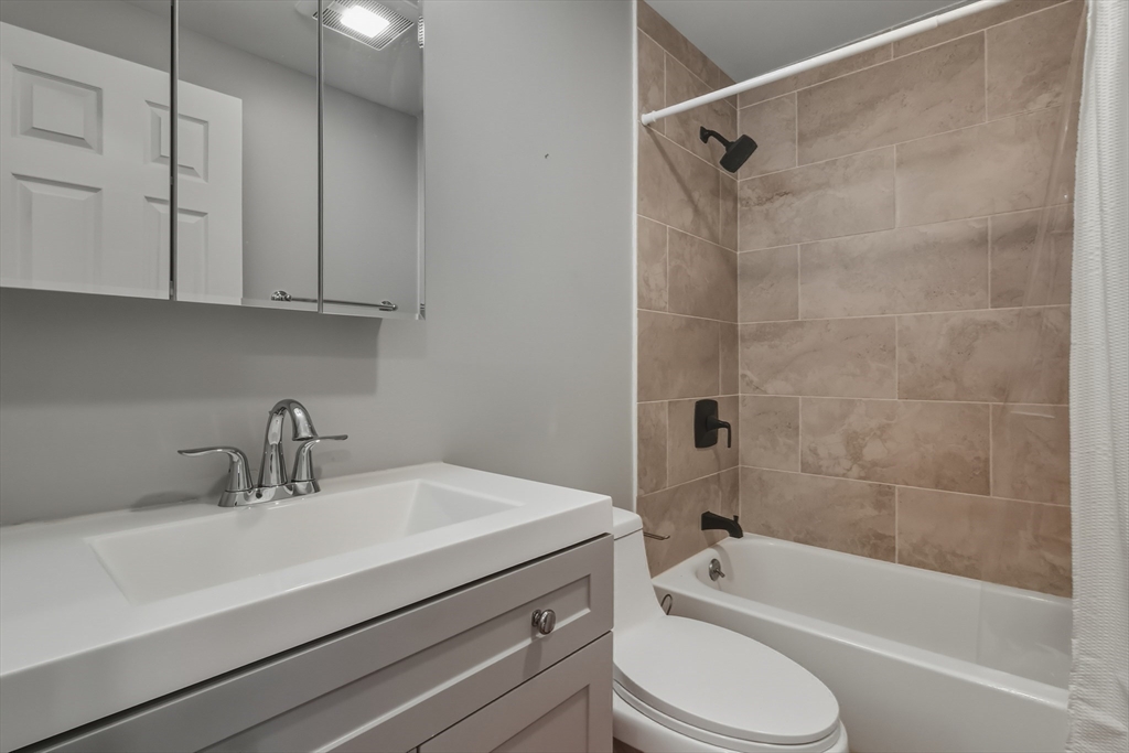 19 Delford Street Boston, MA 02131 - Photo 11 of 27 a bathroom with a sink a toilet and a bathtub