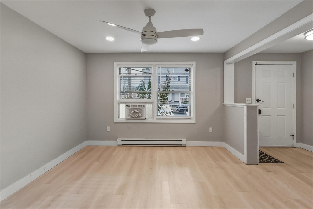 19 Delford Street Boston, MA 02131 - Photo 17 of 27 wooden floor in an empty room with a window