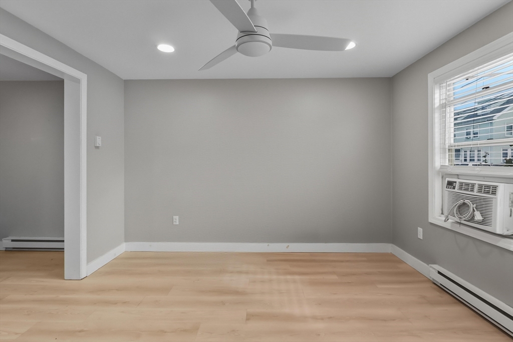 19 Delford Street Boston, MA 02131 - Photo 18 of 27 a view of empty room with wooden floor and fan