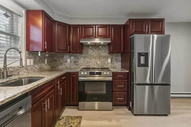 a kitchen with a refrigerator sink and cabinets