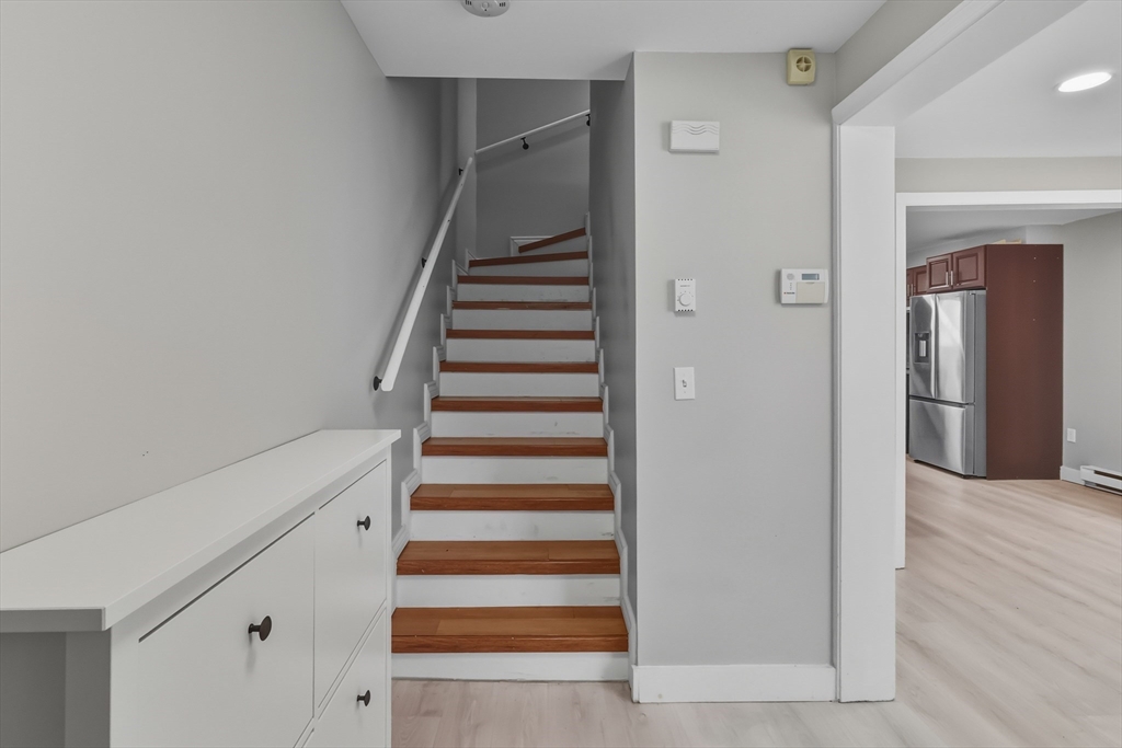 19 Delford Street Boston, MA 02131 - Photo 7 of 27 a view of a hallway with wooden floor and entryway
