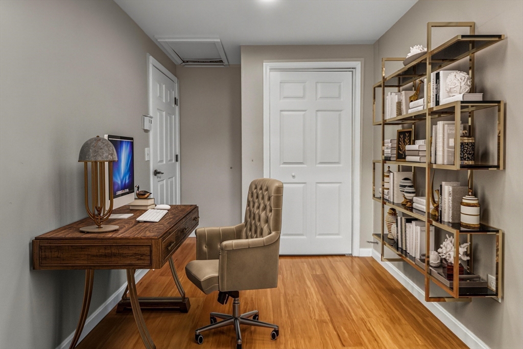 19 Delford Street Boston, MA 02131 - Photo 10 of 27 a view of a workspace with furniture and a book shelf