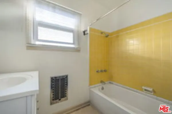 a bathroom with a bathtub and shower