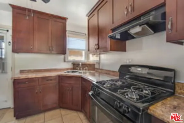 a kitchen with stainless steel appliances granite countertop a stove and a sink