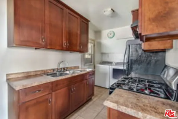 a kitchen with a stove and a refrigerator