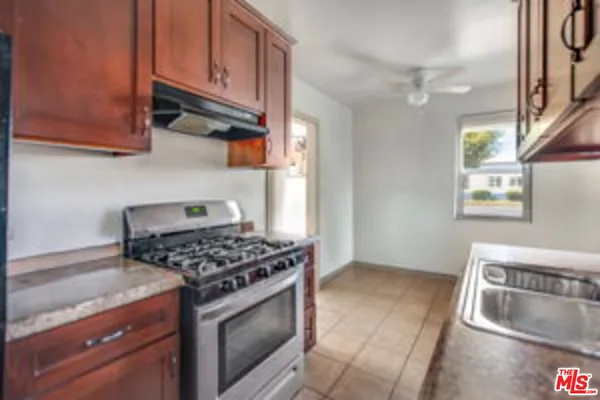 a kitchen with stainless steel appliances granite countertop a stove a sink and a refrigerator