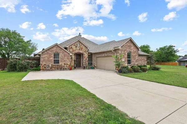 a view of house that has a yard