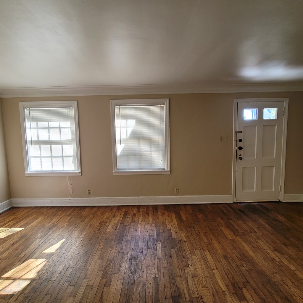 1703 39th Street, Unit B Columbus, GA 31904 - Photo 2 of 8 an empty room with wooden floor and windows