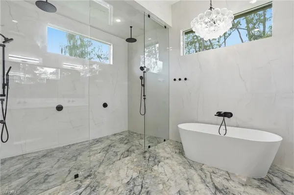 a bathroom with double vanity a mirror a double and a shower