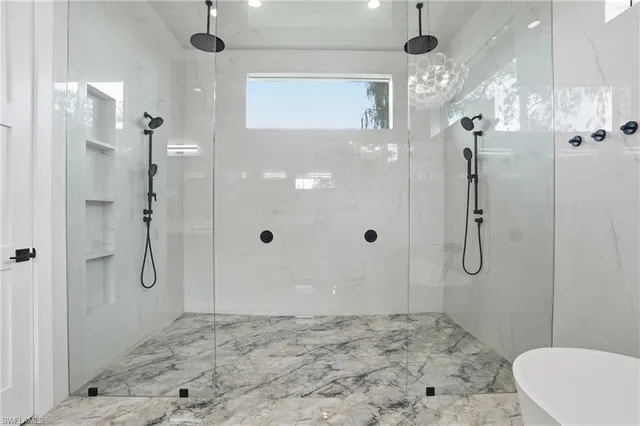a spacious bathroom with a bathtub and shower