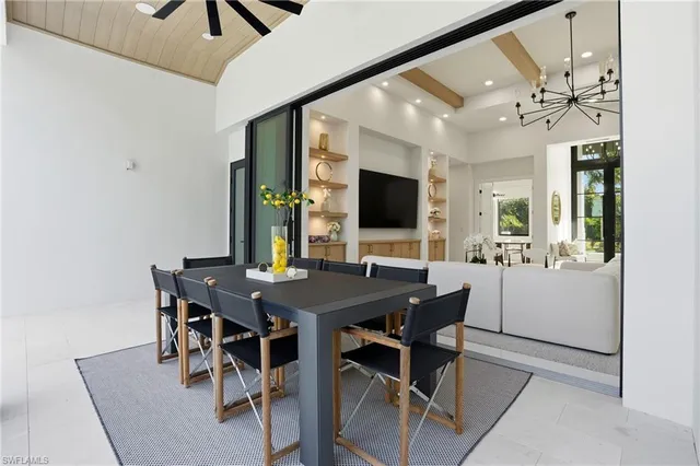 a view of a dining room with a table and chairs