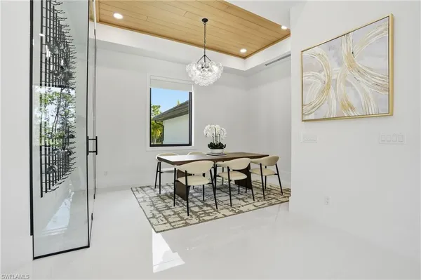 a view of a dining room with a table and chairs