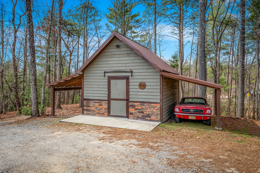 259 Red Bush School Road Blue Ridge, GA 30513 - Photo 22 of 46 Additional covered parking space beside powered storage shed, ideal for workshop or hobby space