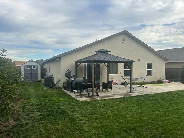a front view of house with yard and seating area