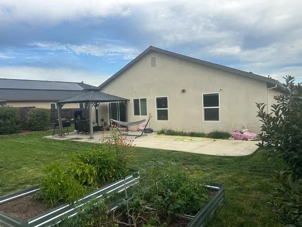 a house view with swimming pool and garden space