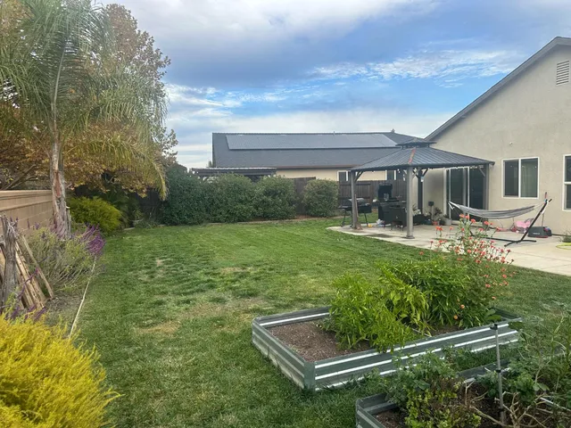 a view of a backyard with sitting area
