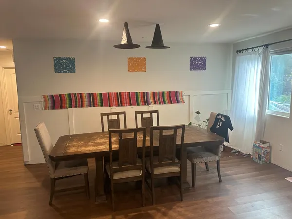 a view of a dining room with furniture and wooden floor