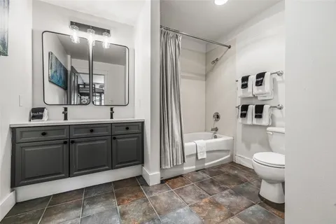 a spacious bathroom with a sink toilet and shower