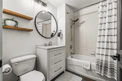 a bathroom with a toilet a sink and a mirror