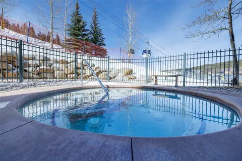 a living room with fireplace furniture and a chandelier