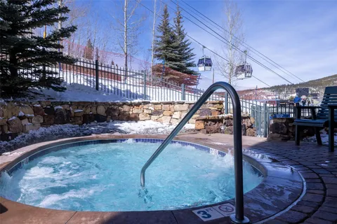 a view of a hallway with wooden floor and windows