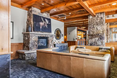 a living room with fireplace furniture and a chandelier