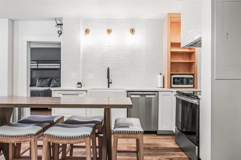 a kitchen with stainless steel appliances granite countertop a stove and a refrigerator