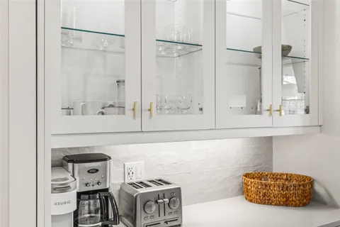 a kitchen with stainless steel appliances cabinets and a window