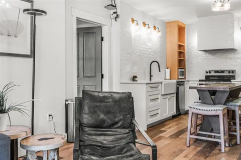 a kitchen with cabinets and chairs