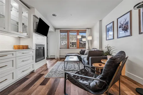 a living room with furniture and flat screen tv