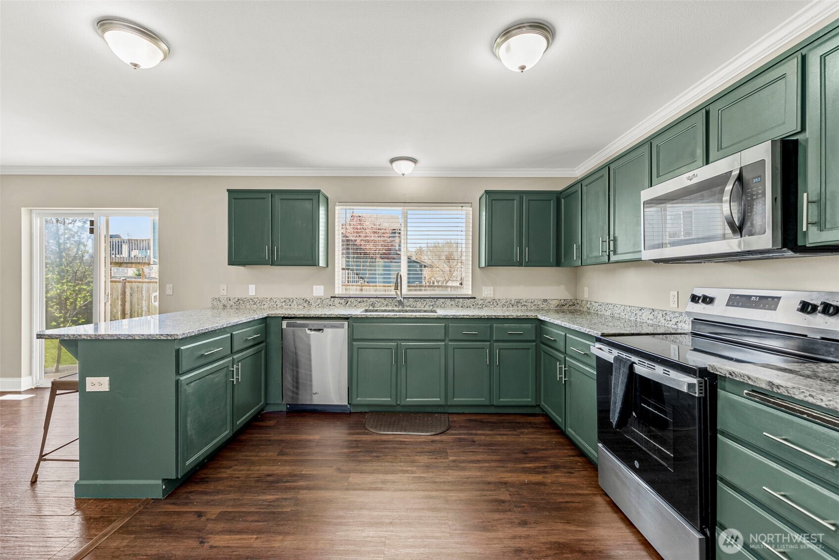 9115 Paradise View Street Yelm, WA 98597 - Photo 11 of 40 a kitchen with granite countertop cabinets stainless steel appliances and a sink