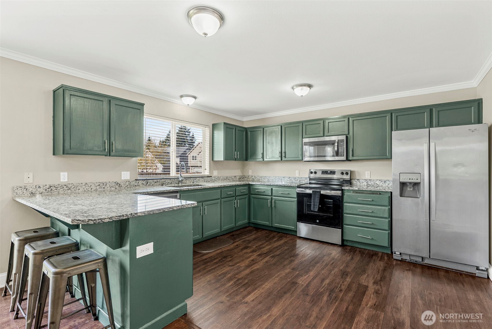 9115 Paradise View Street Yelm, WA 98597 - Photo 12 of 40 a kitchen with a sink window and stainless steel appliances