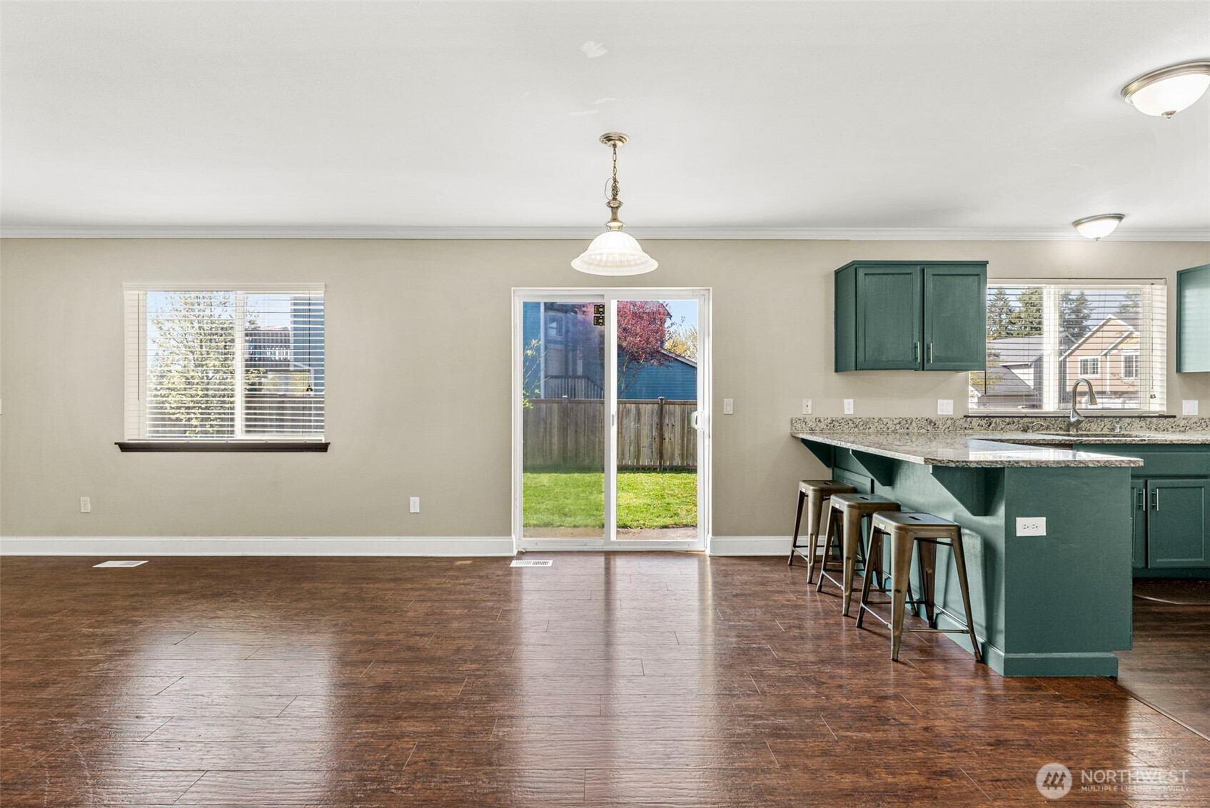 9115 Paradise View Street Yelm, WA 98597 - Photo 14 of 40 a view of a dining room with furniture window and wooden floor