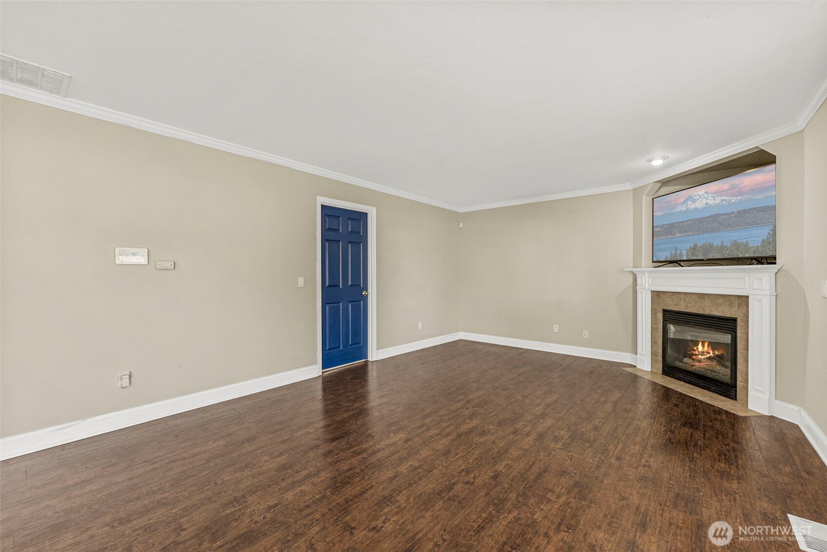 9115 Paradise View Street Yelm, WA 98597 - Photo 16 of 40 a view of an empty room with a fireplace and a window