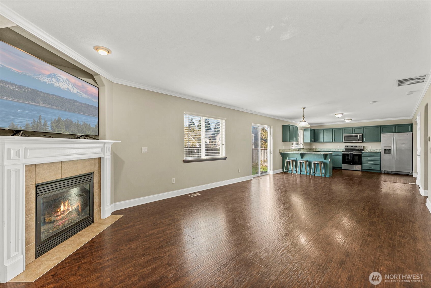 9115 Paradise View Street Yelm, WA 98597 - Photo 18 of 40 a view of a livingroom with wooden floor and a fireplace