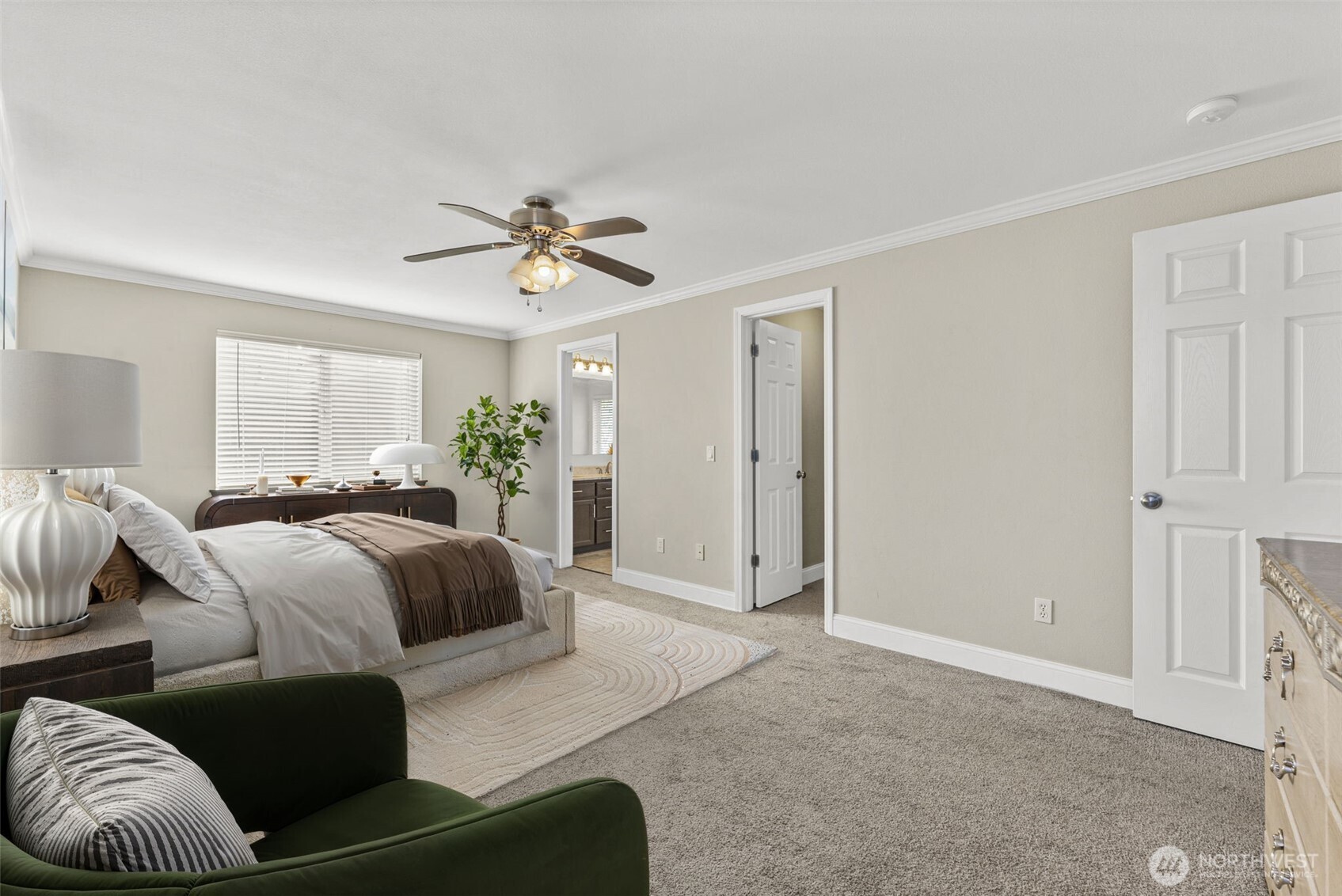 9115 Paradise View Street Yelm, WA 98597 - Photo 25 of 40 a spacious bedroom with a bed and a chandelier