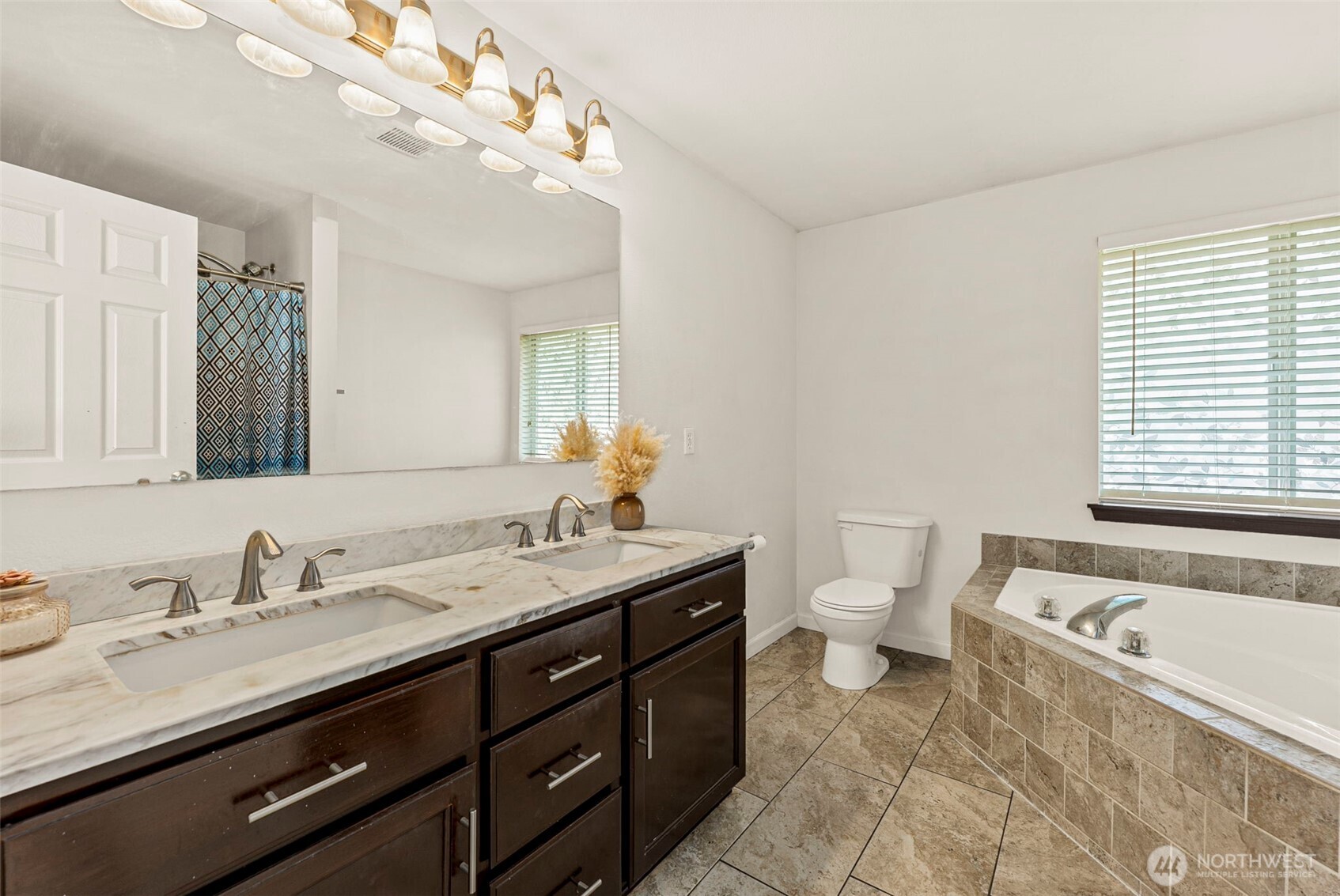 9115 Paradise View Street Yelm, WA 98597 - Photo 27 of 40 a bathroom with a granite countertop sink a toilet and a mirror
