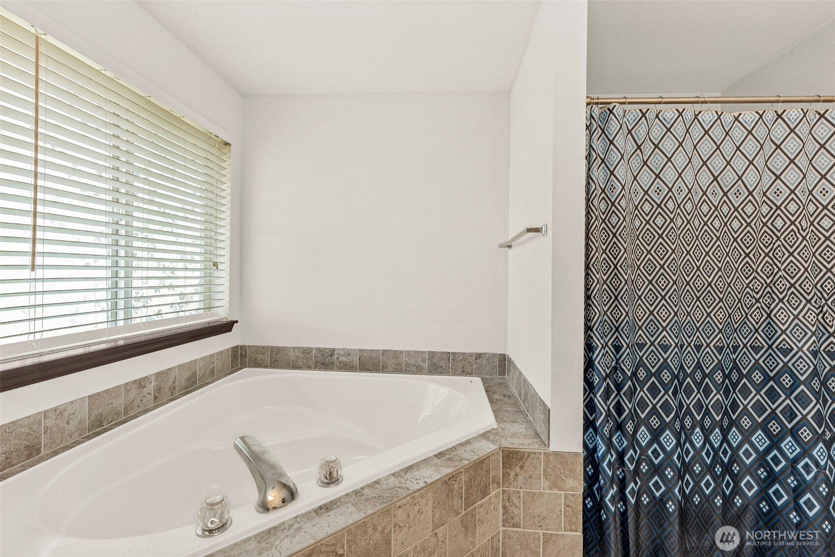 9115 Paradise View Street Yelm, WA 98597 - Photo 28 of 40 a bath tub sitting in a bathroom next to a window