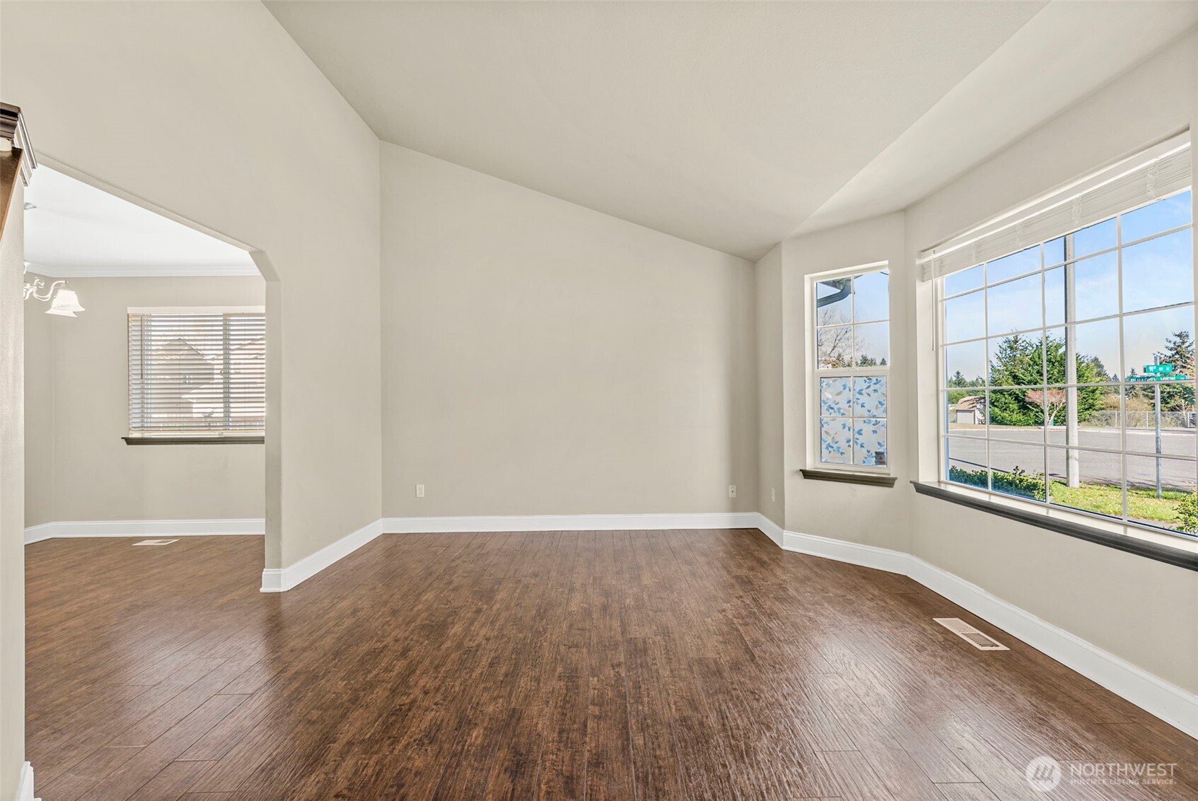 9115 Paradise View Street Yelm, WA 98597 - Photo 4 of 40 an empty room with wooden floor and windows