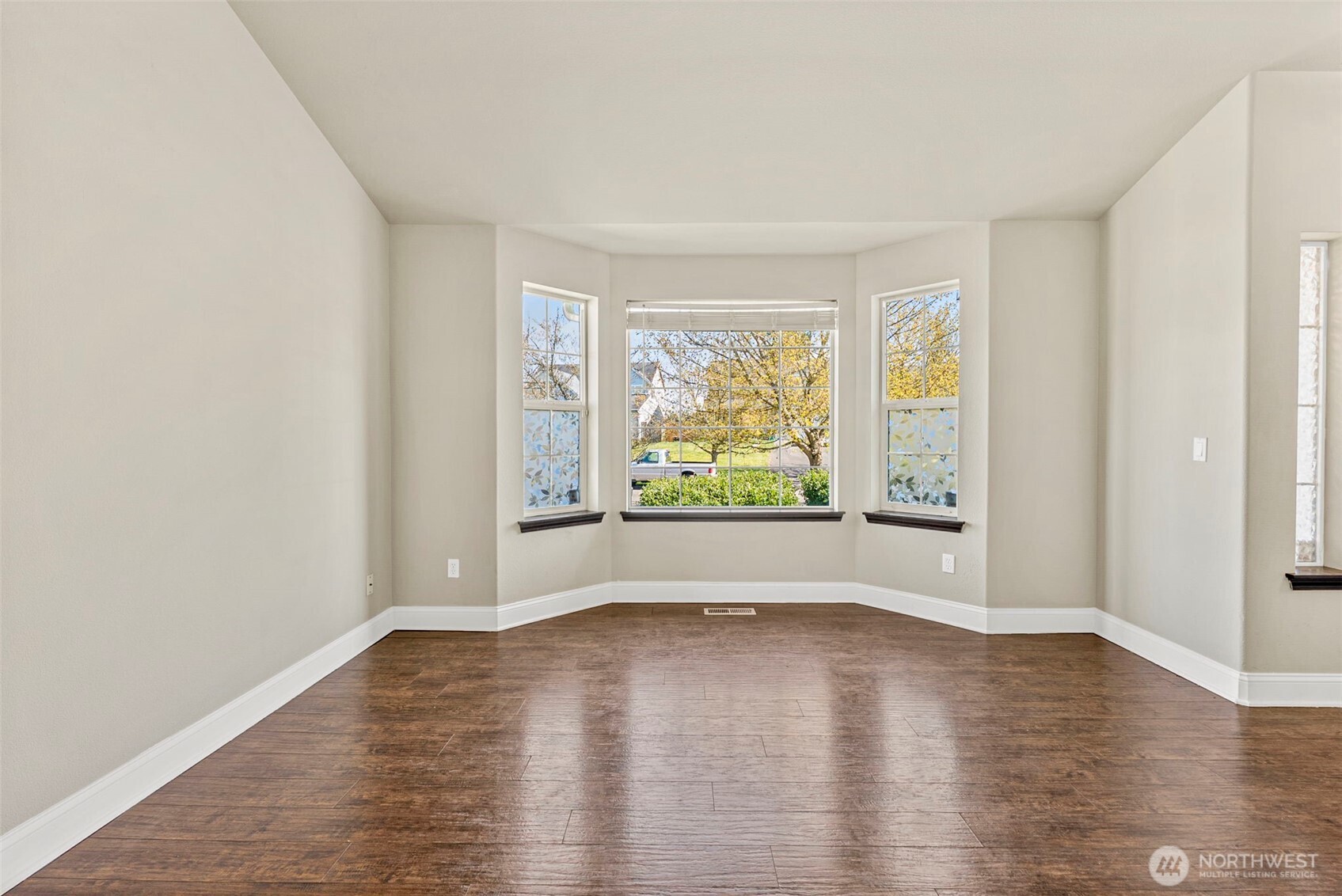 9115 Paradise View Street Yelm, WA 98597 - Photo 5 of 40 wooden floor in an empty room with a window