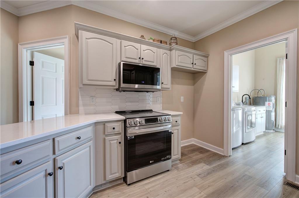 264 Boone Ford Road Southeast Calhoun, GA 30701 - Photo 18 of 66 a kitchen with stainless steel appliances a stove microwave and refrigerator