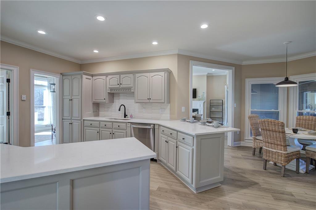 264 Boone Ford Road Southeast Calhoun, GA 30701 - Photo 20 of 66 a kitchen with stainless steel appliances sink stove refrigerator and cabinets