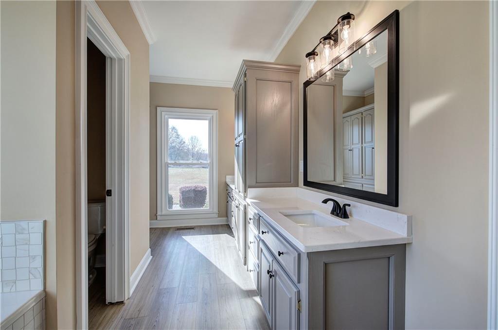264 Boone Ford Road Southeast Calhoun, GA 30701 - Photo 26 of 66 a bathroom with a sink and a mirror