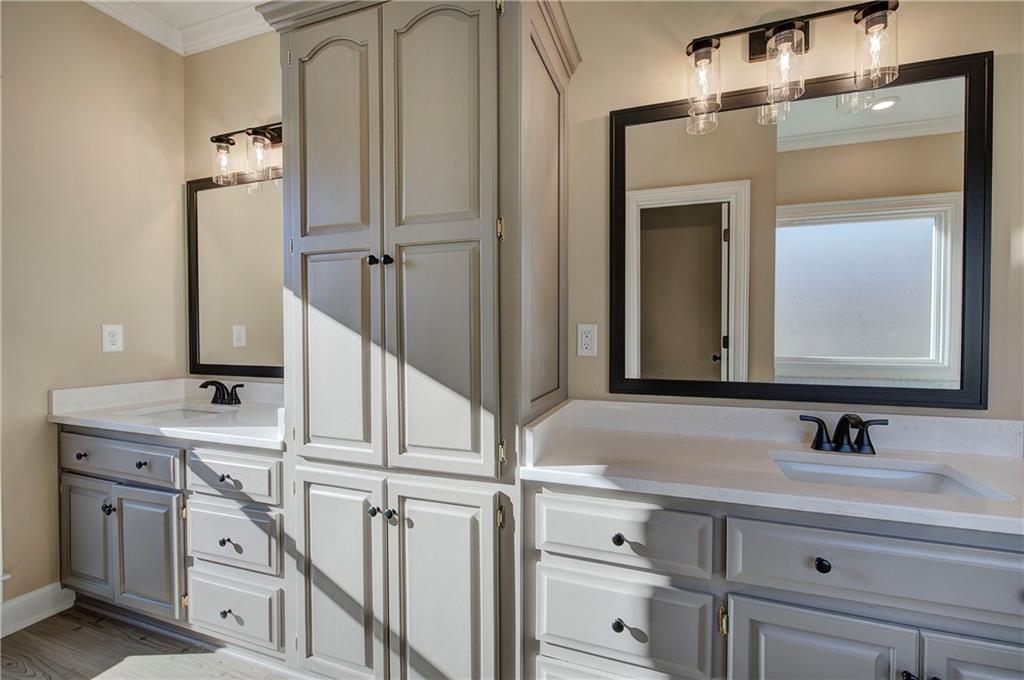 264 Boone Ford Road Southeast Calhoun, GA 30701 - Photo 27 of 66 a bathroom with a sink vanity and mirror