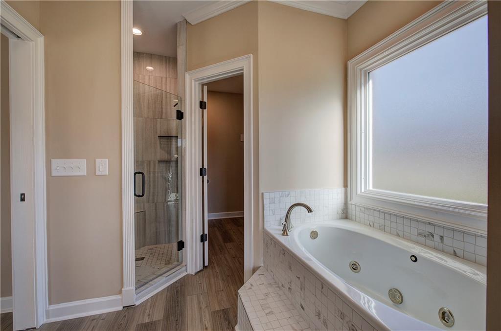 264 Boone Ford Road Southeast Calhoun, GA 30701 - Photo 29 of 66 a bathroom with a bathtub and shower