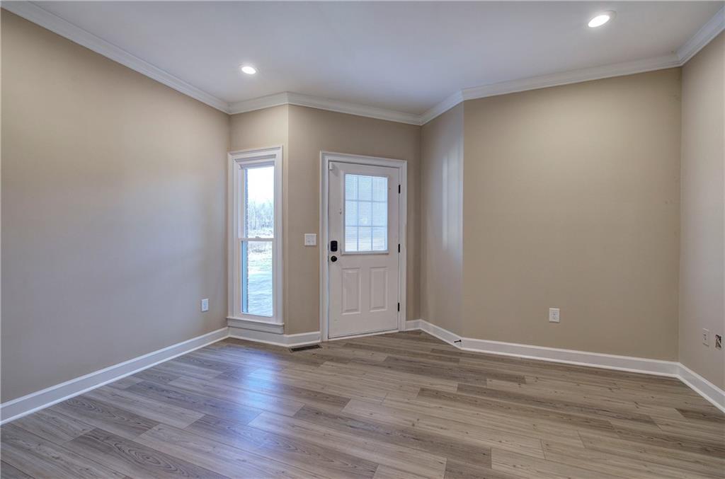 264 Boone Ford Road Southeast Calhoun, GA 30701 - Photo 32 of 66 a view of an empty room with wooden floor and a window