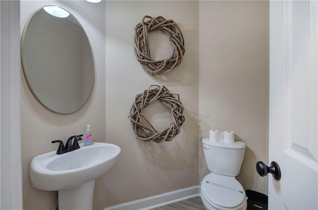 264 Boone Ford Road Southeast Calhoun, GA 30701 - Photo 33 of 66 a bathroom with a toilet a sink and a mirror
